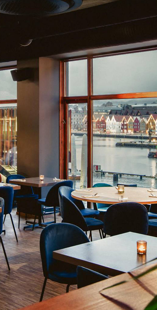 Modern Restaurant Interior Overlooking Waterfront Cityscape