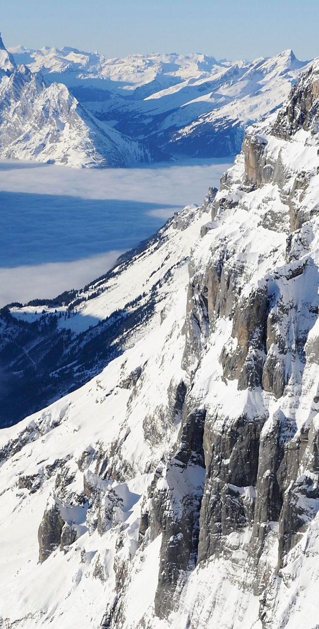 Snow-covered mountain peaks under clear sky