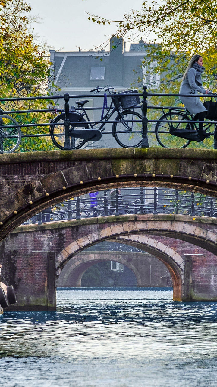 Scenic canal bridge with bicycles in autumn