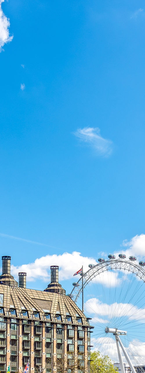 Big Ben and London Eye under blue sky