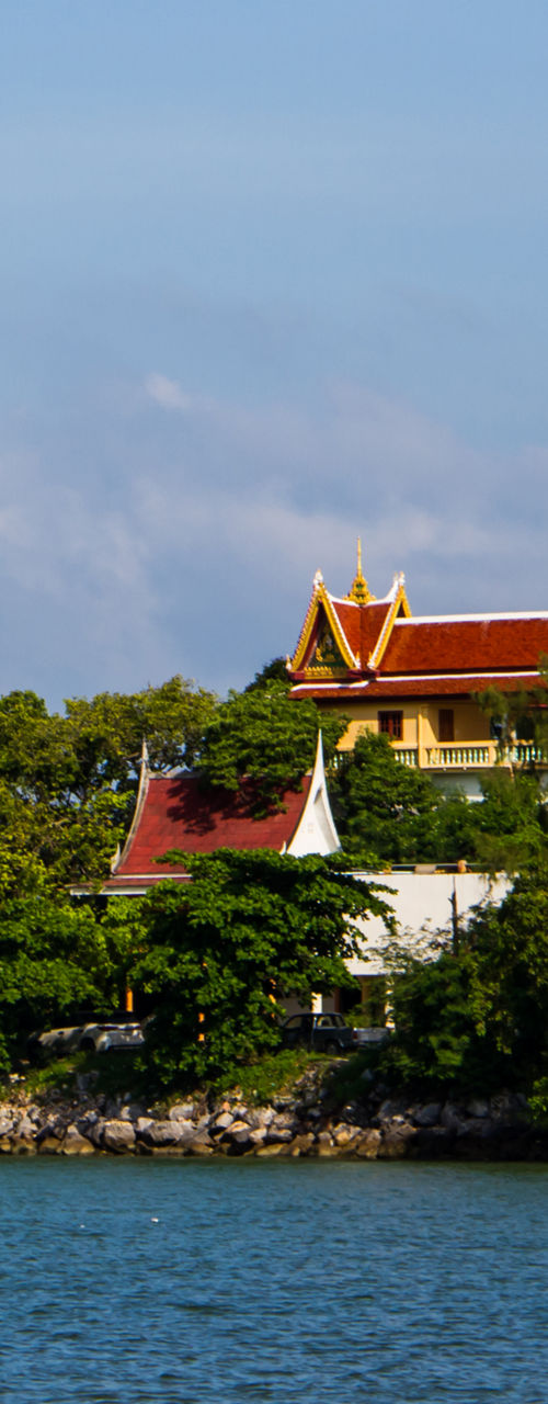 Golden Buddha statue on hill by the sea
