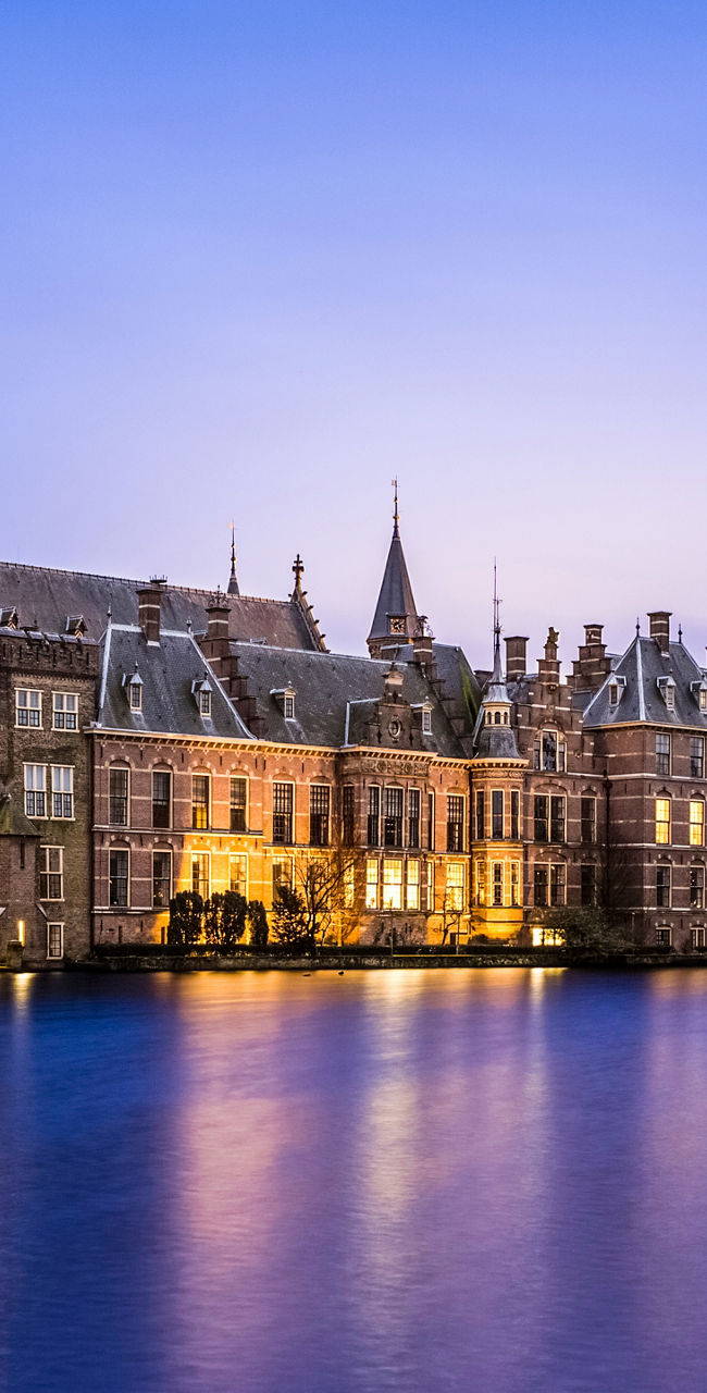 Historic Dutch building by illuminated water