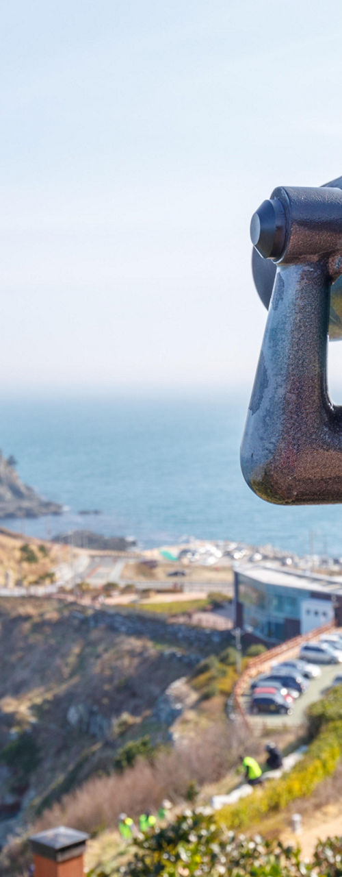 Coin-operated binoculars overlooking coastal cliffs