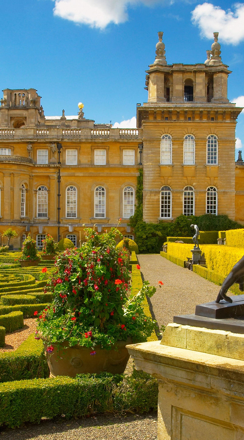 Historic palace with ornate gardens and statue