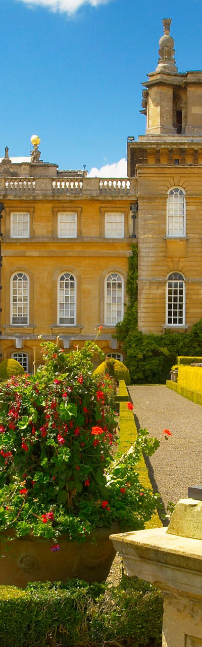 Historic palace with ornate gardens and statue