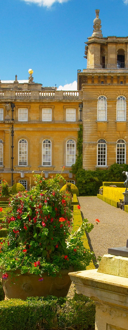 Historic palace with ornate gardens and statue