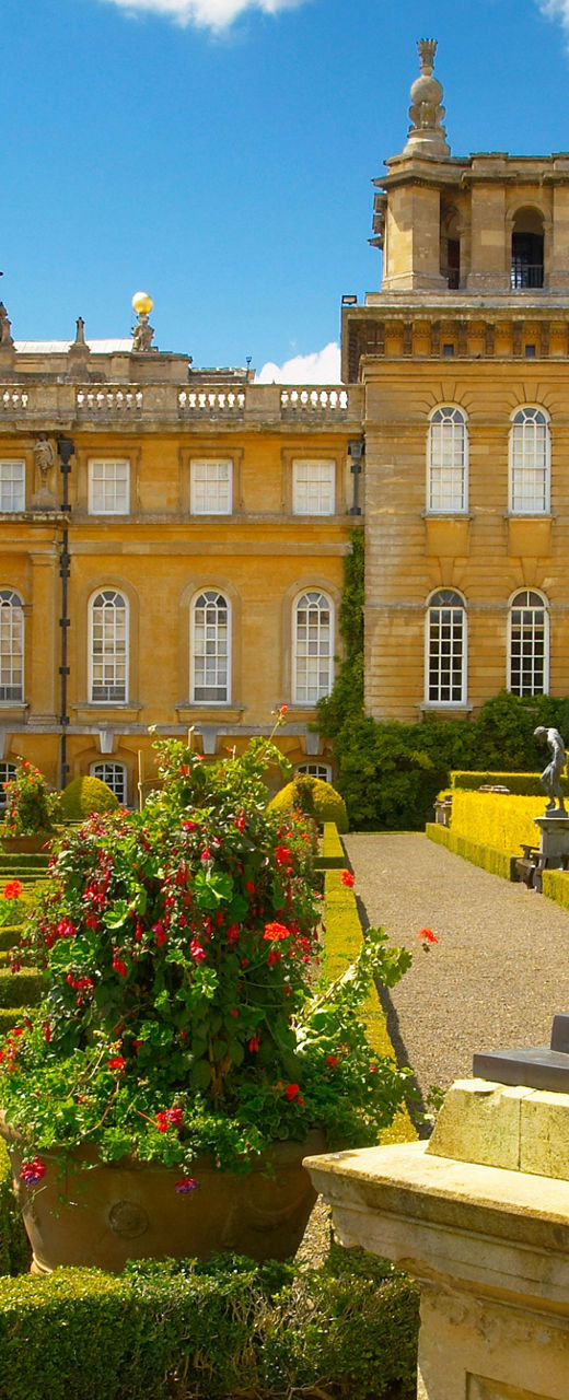 Historic palace with ornate gardens and statue