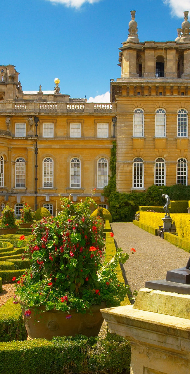 Historic palace with ornate gardens and statue