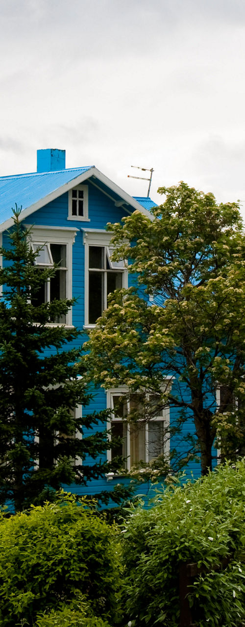 Blue house in scenic countryside setting