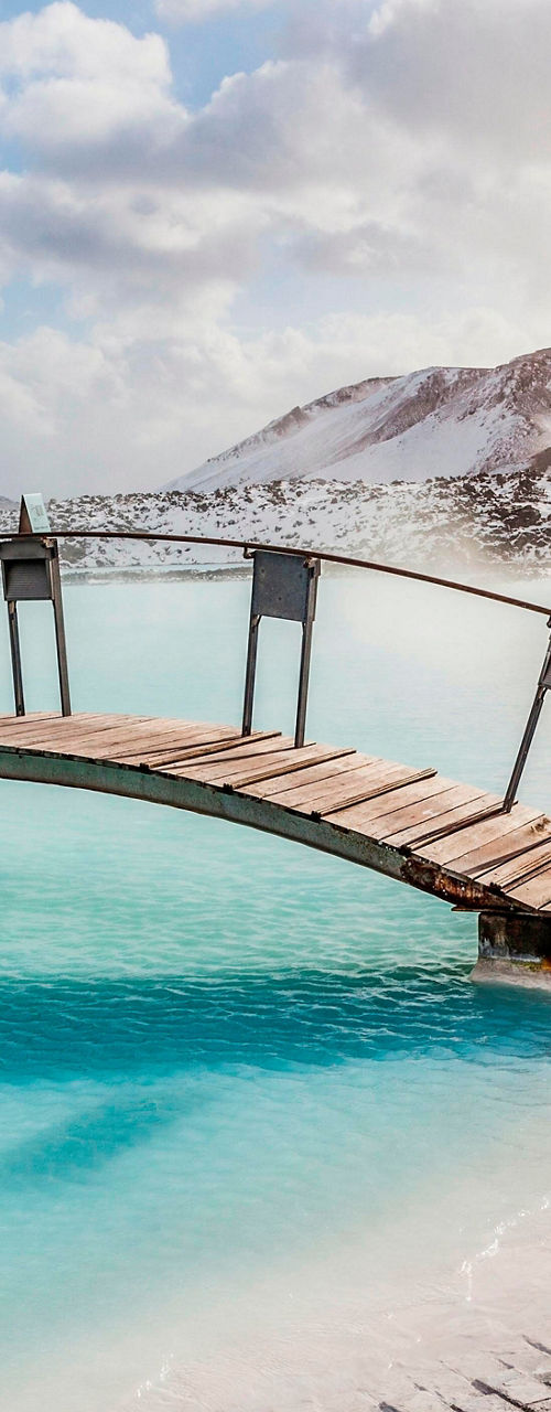 Scenic geothermal spa with wooden bridge