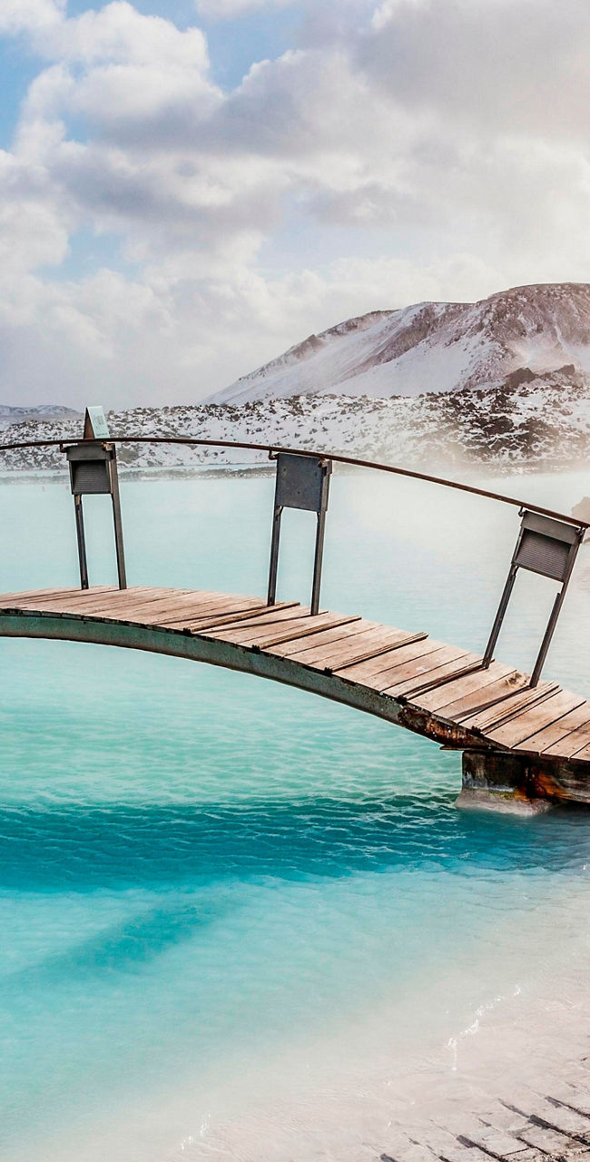 Scenic geothermal spa with wooden bridge