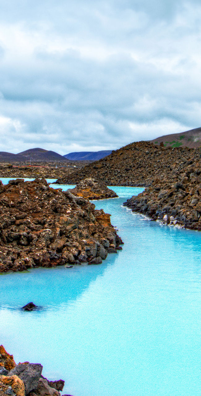 Scenic geothermal lagoon with rocky terrain