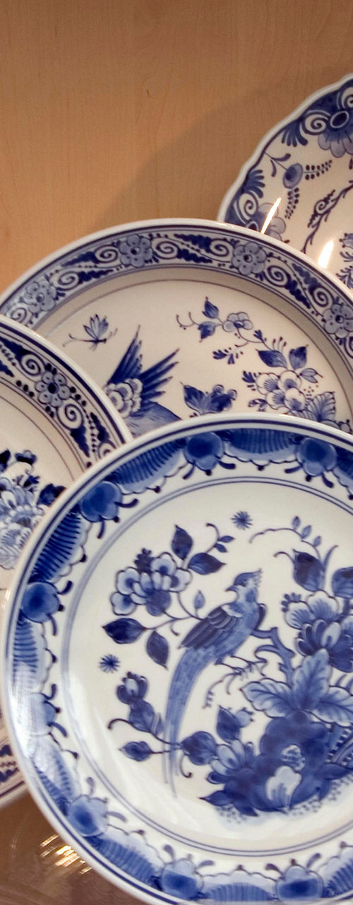 Blue and white ceramic plates and vase display