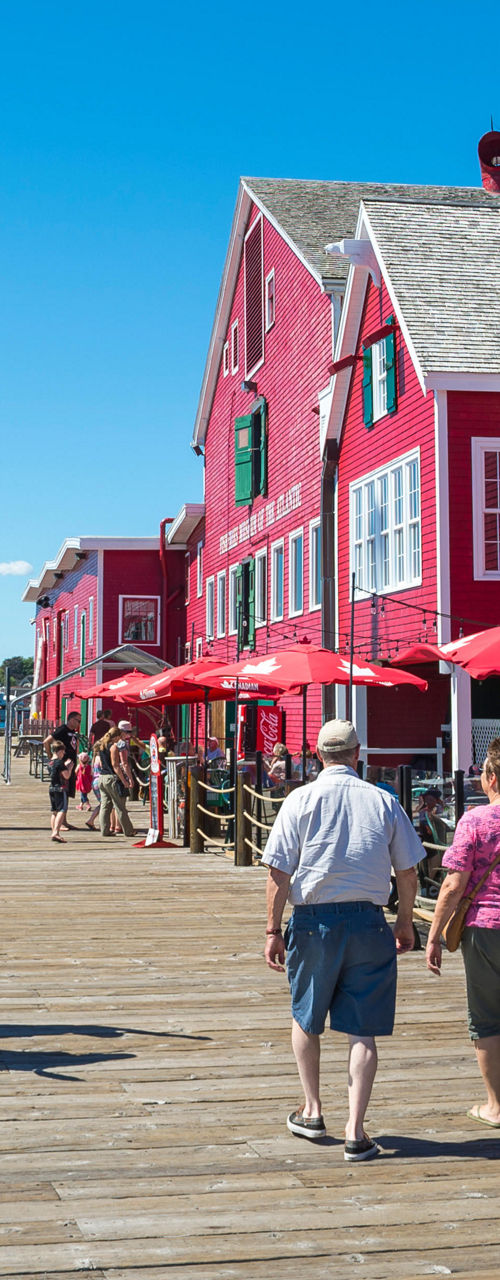 Scenic waterfront with red buildings and docked boats