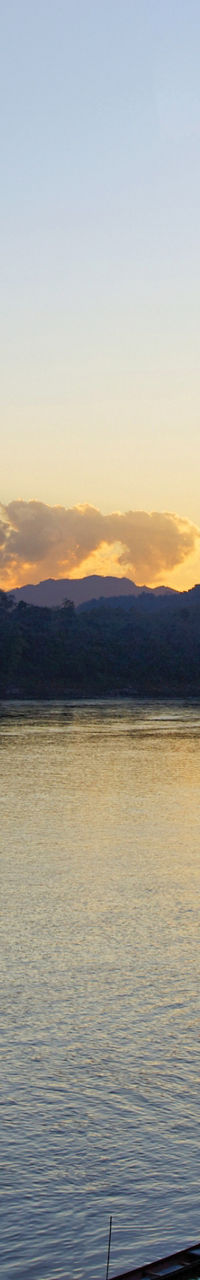 Serene lake at sunset with docked boats