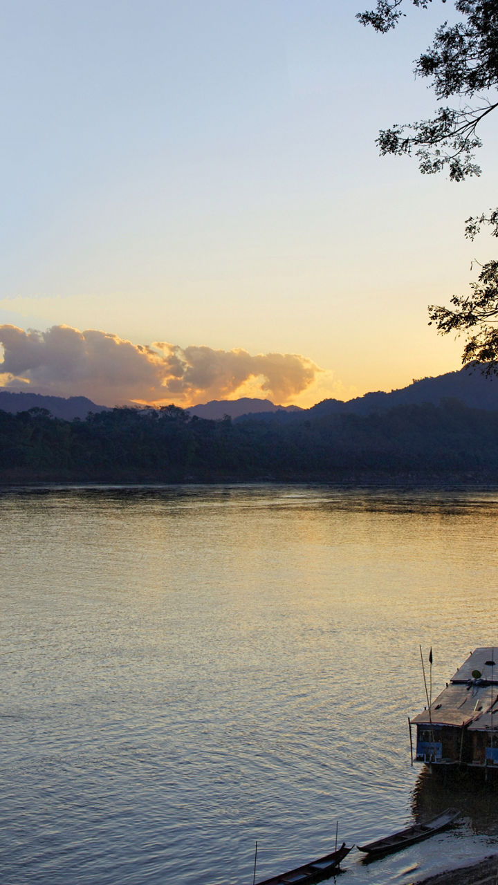 Serene lake at sunset with docked boats
