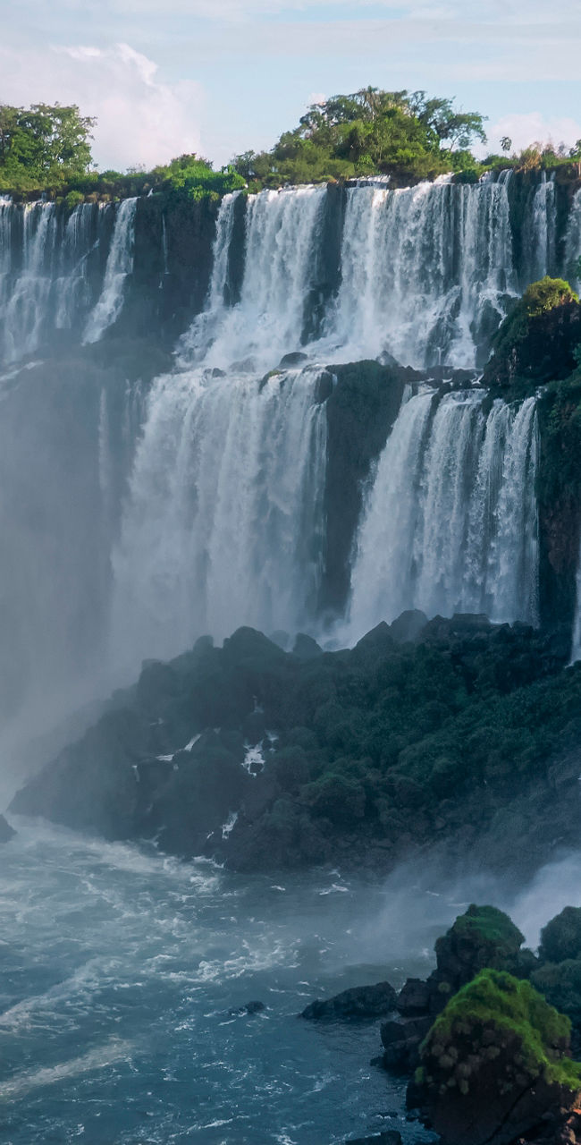 Boat approaching majestic Iguazu waterfalls