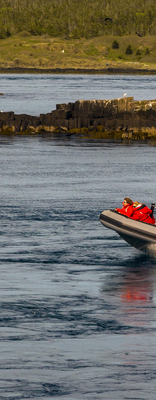 Tourists on inflatable boat in scenic waters