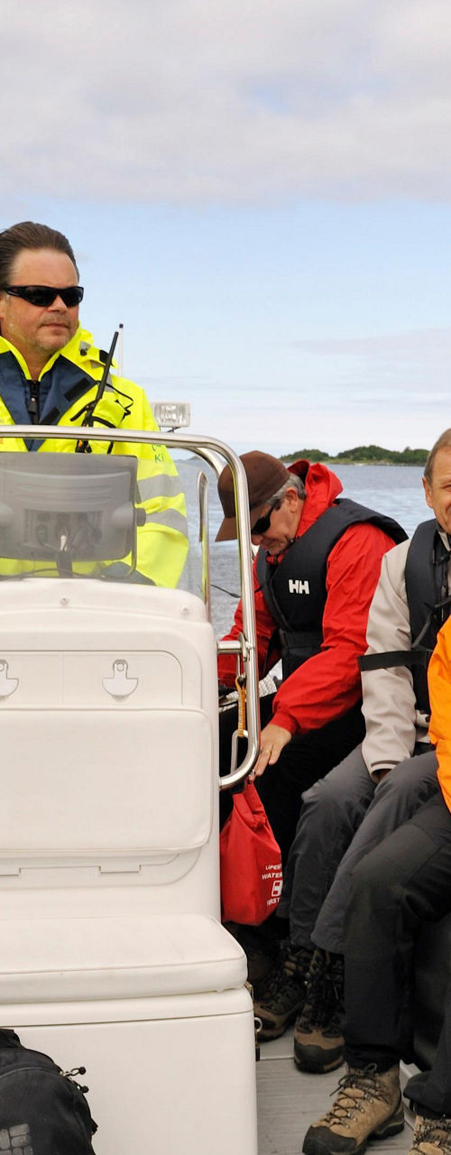 Group on inflatable boat in scenic waters