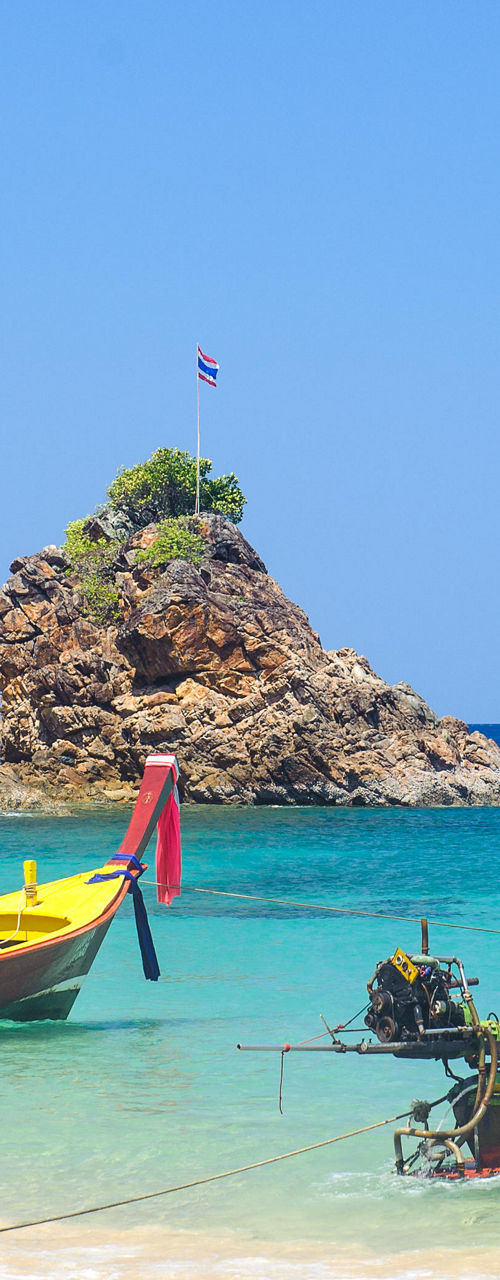 Traditional Thai boats on tropical beach