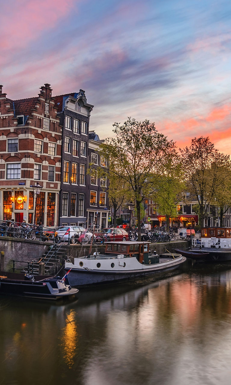 Scenic Amsterdam canal at sunset