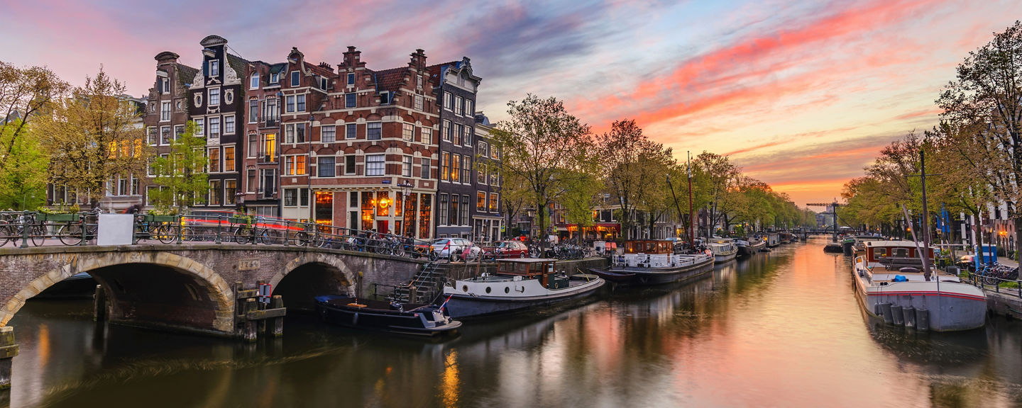 Scenic Amsterdam canal at sunset