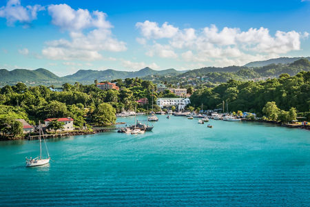 Scenic harbor with sailboats and lush hills