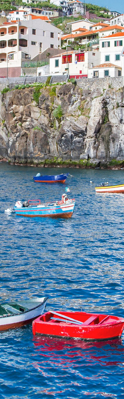 Colorful boats in Madeira coastal village
