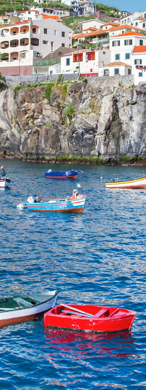 Colorful boats in Madeira coastal village