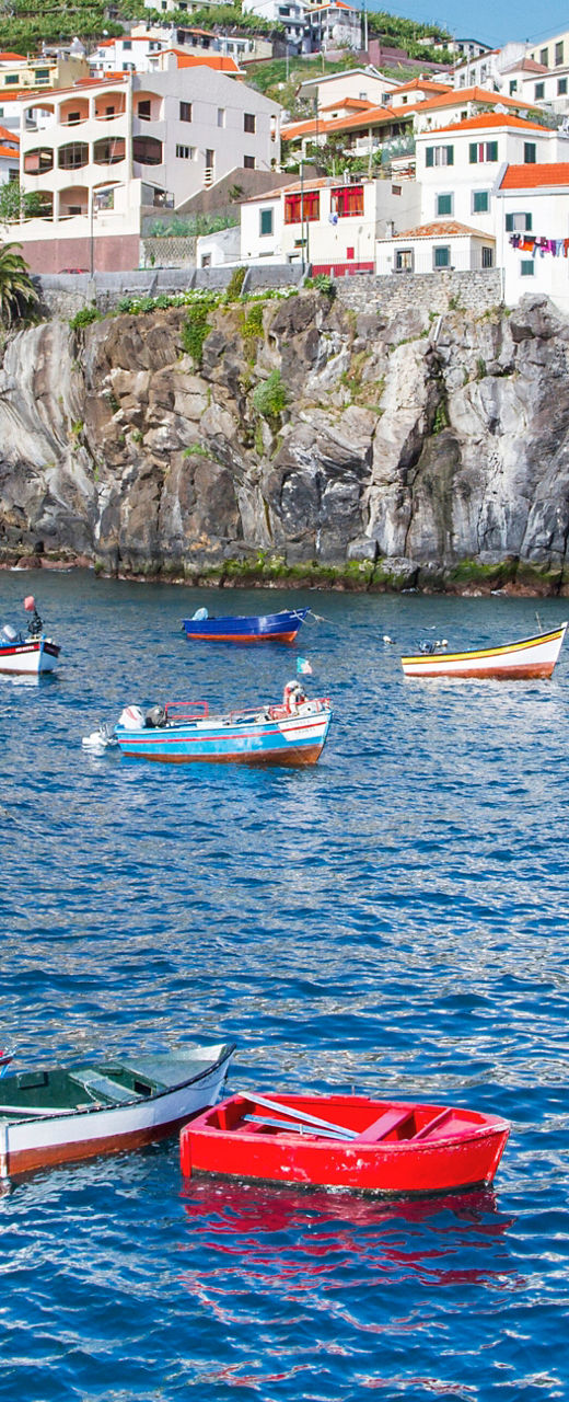 Colorful boats in Madeira coastal village