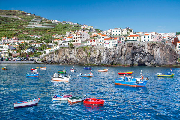 Colorful boats in Madeira coastal village