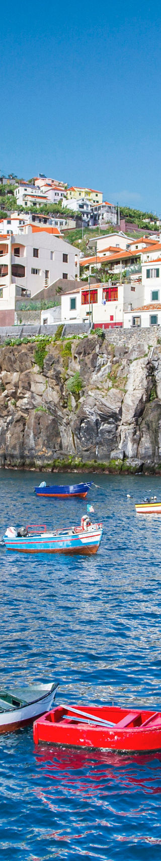 Colorful boats in Madeira coastal village