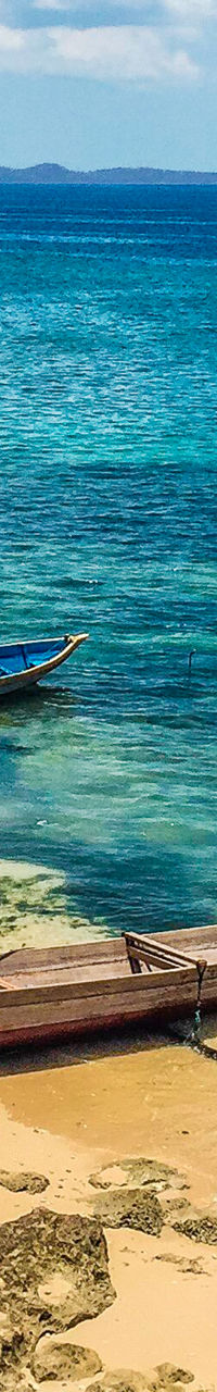 Colorful boats on tropical beach shore
