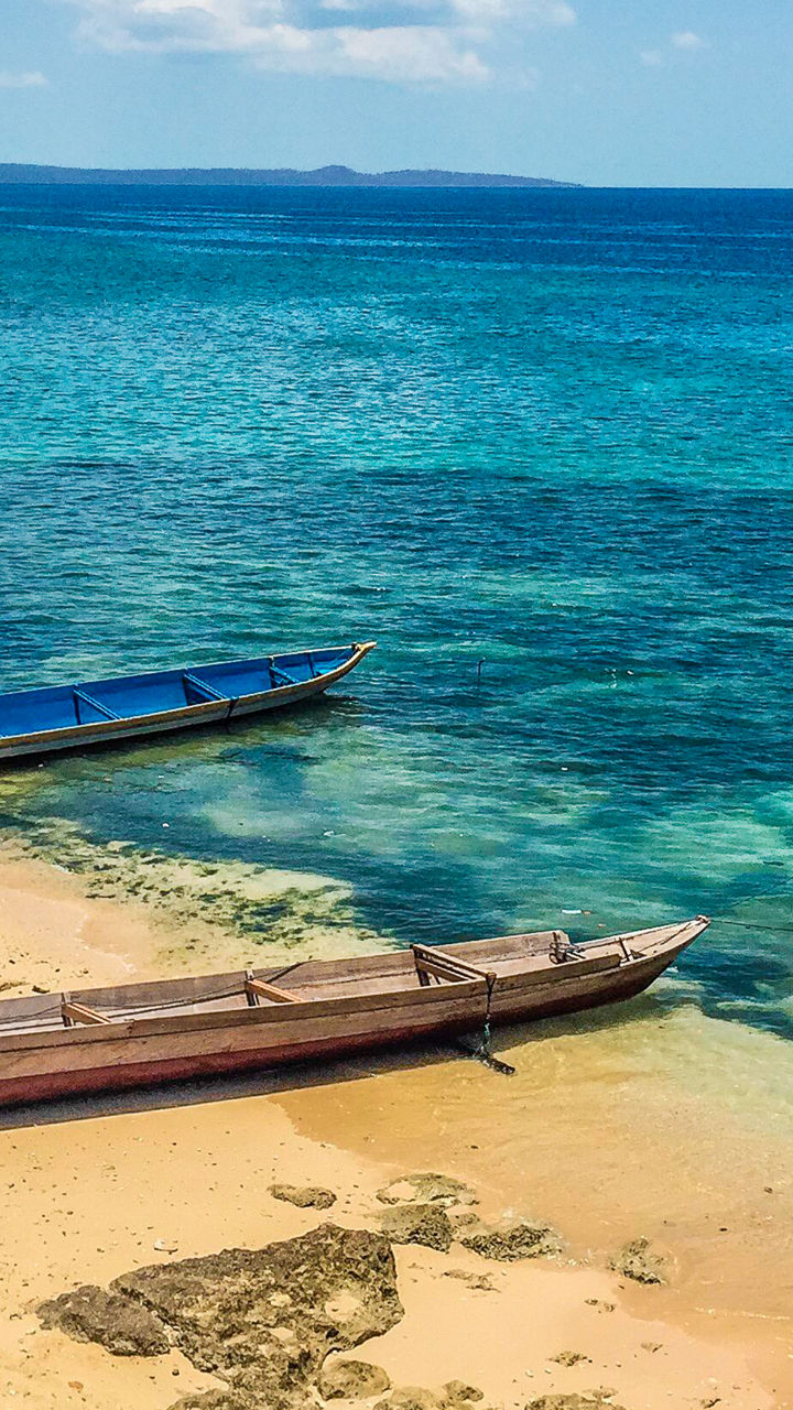 Colorful boats on tropical beach shore