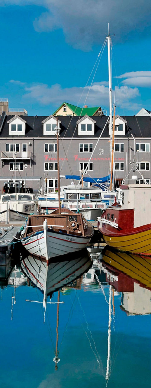 Colorful harbor with boats and reflections