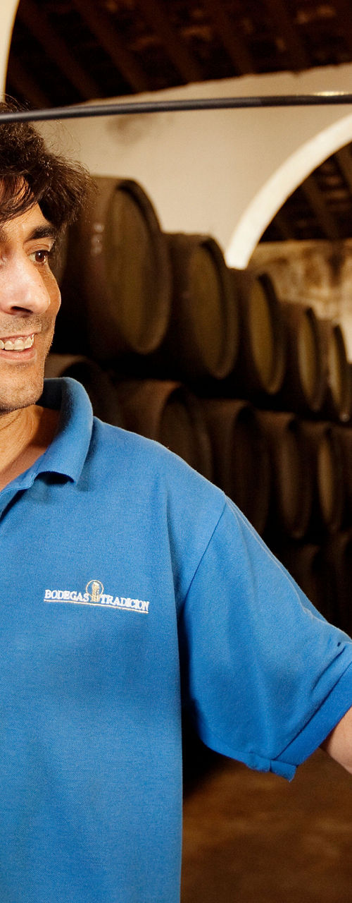Wine cellar worker pouring sherry sample
