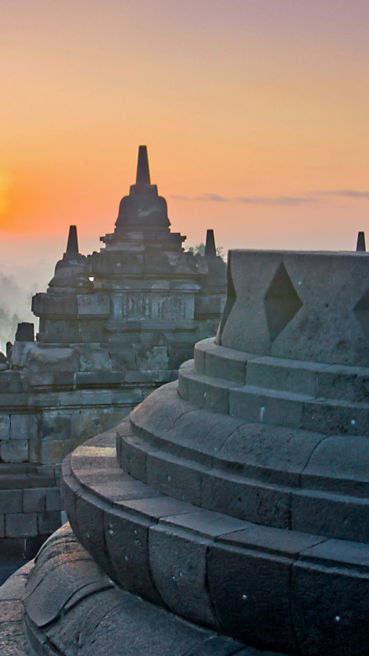 Sunrise at Borobudur Temple with Buddha statue
