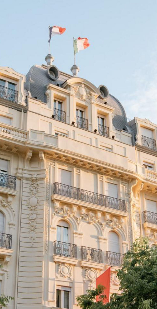 Elegant historic building with French flags