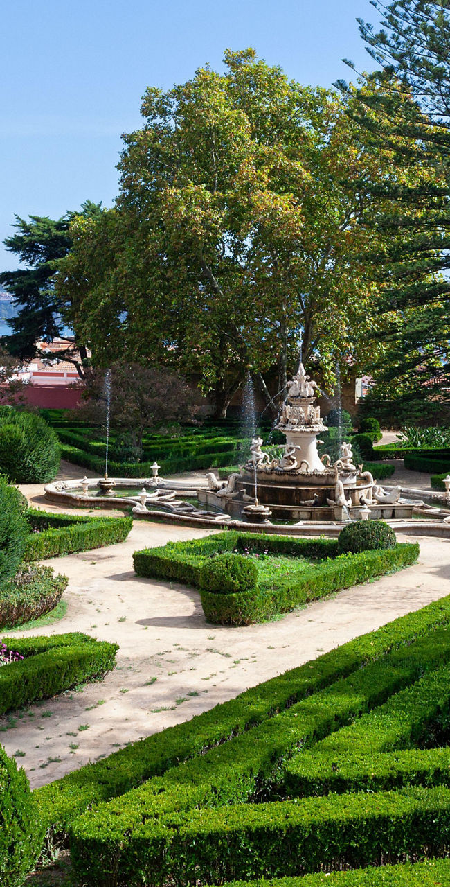 Manicured garden with fountain and bridge view