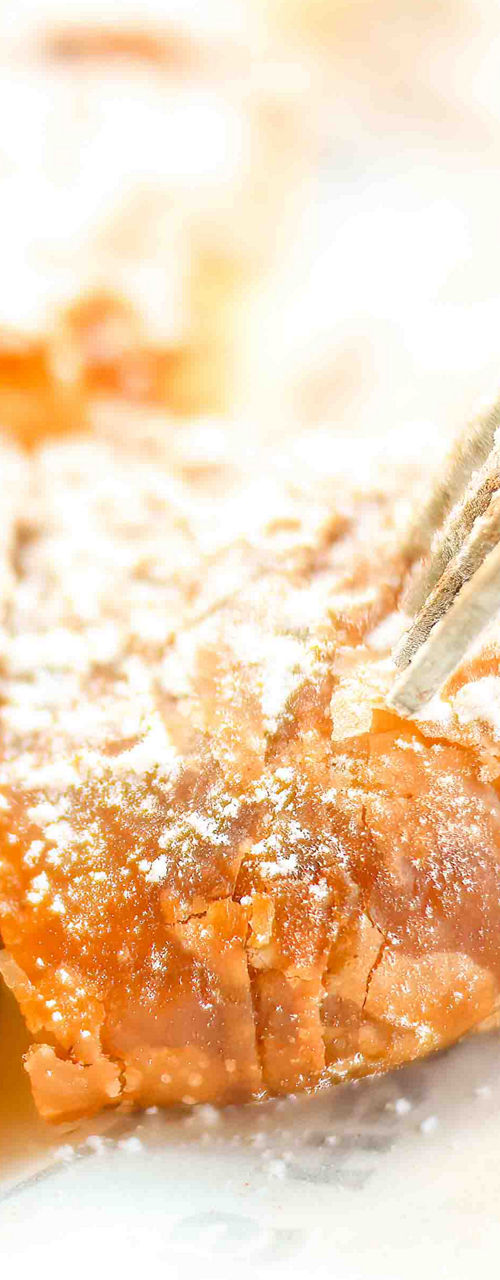 Fork cutting powdered sugar pastry squares