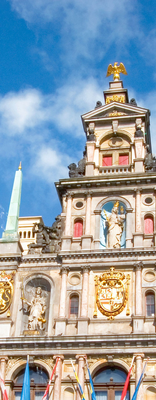 Historic Antwerp building with statue foreground