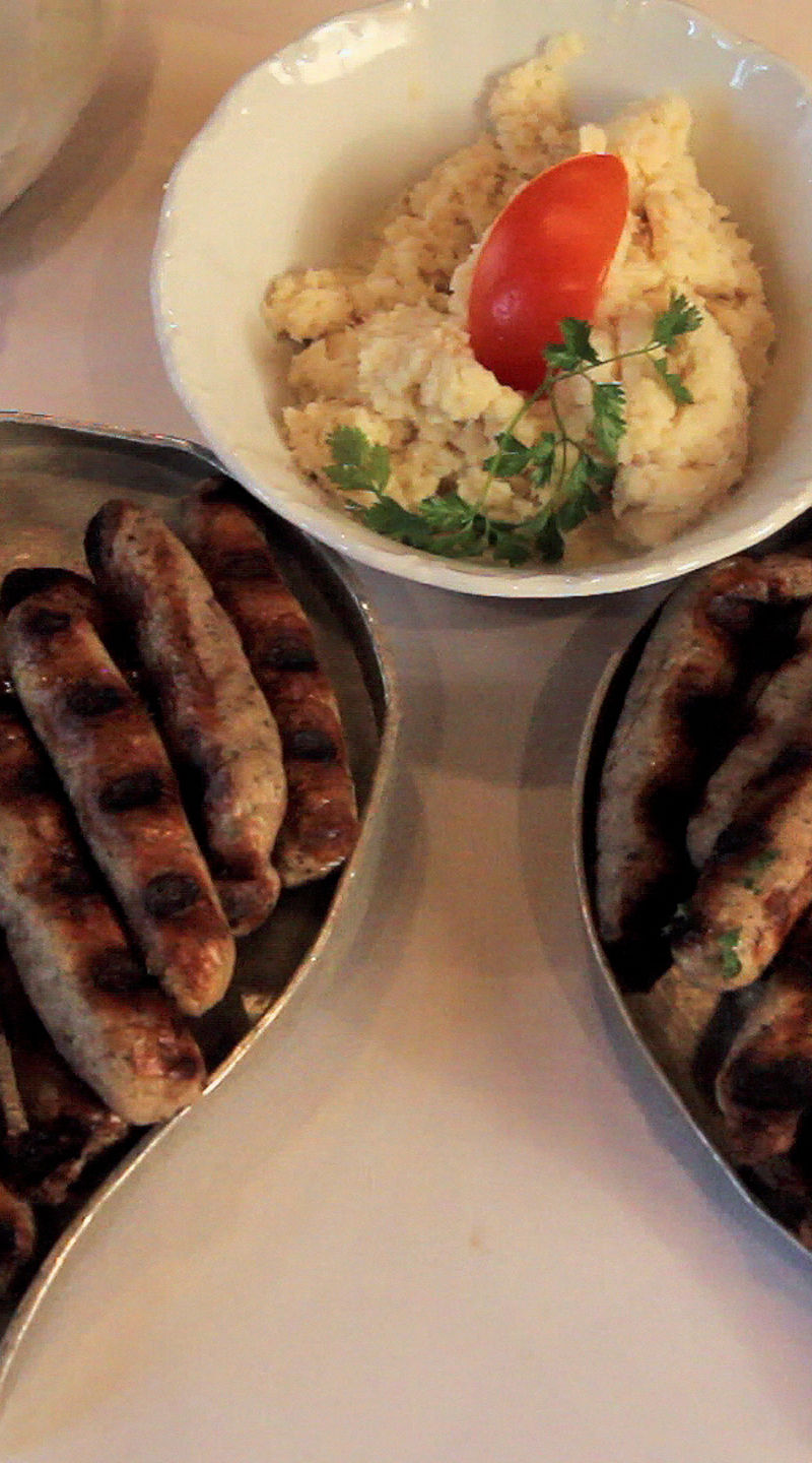 Grilled sausages with sides on plates