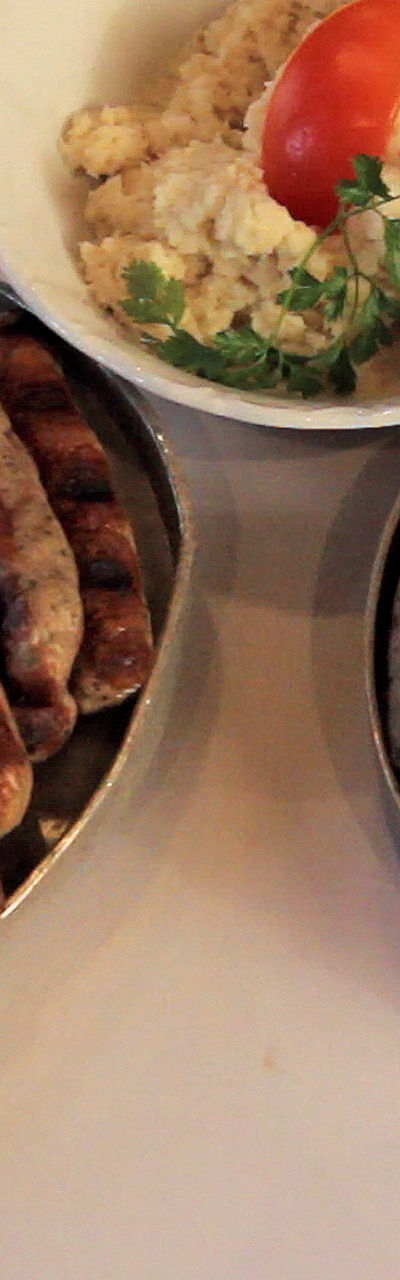 Grilled sausages with sides on plates
