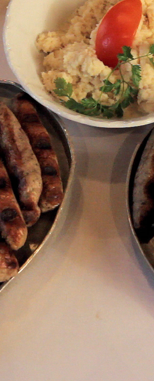 Grilled sausages with sides on plates