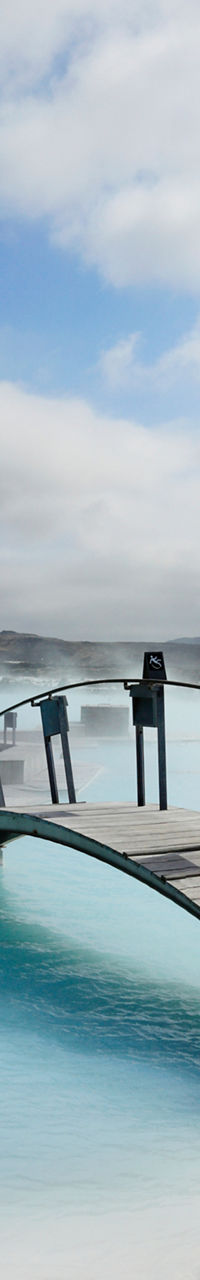 Scenic geothermal spa with wooden bridge