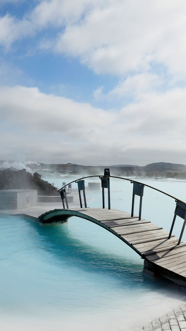 Scenic geothermal spa with wooden bridge