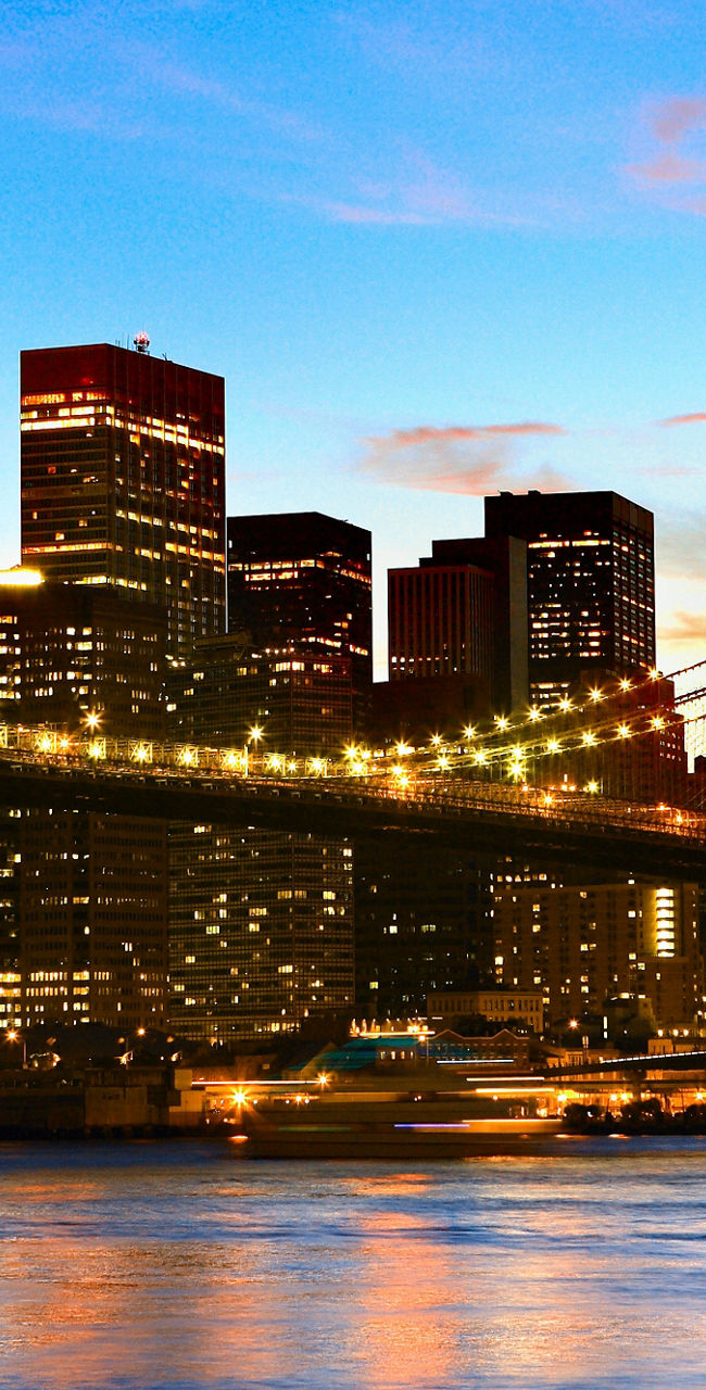 Brooklyn Bridge at sunset with city skyline