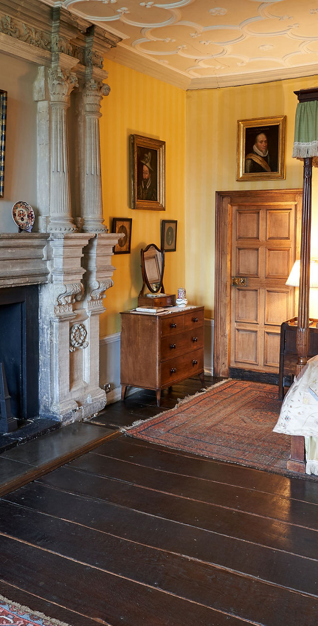 Elegant historic bedroom with ornate fireplace