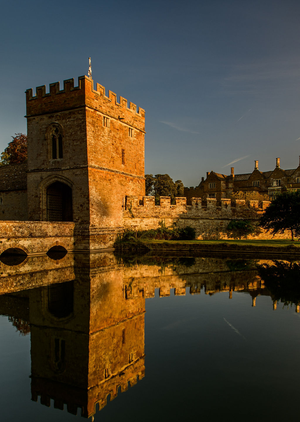 Historic castle with moat at sunset