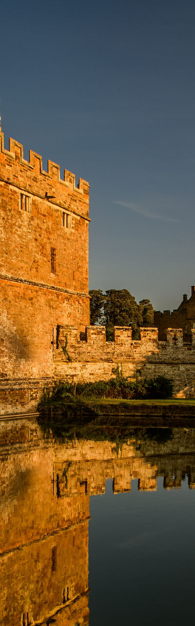 Historic castle with moat at sunset